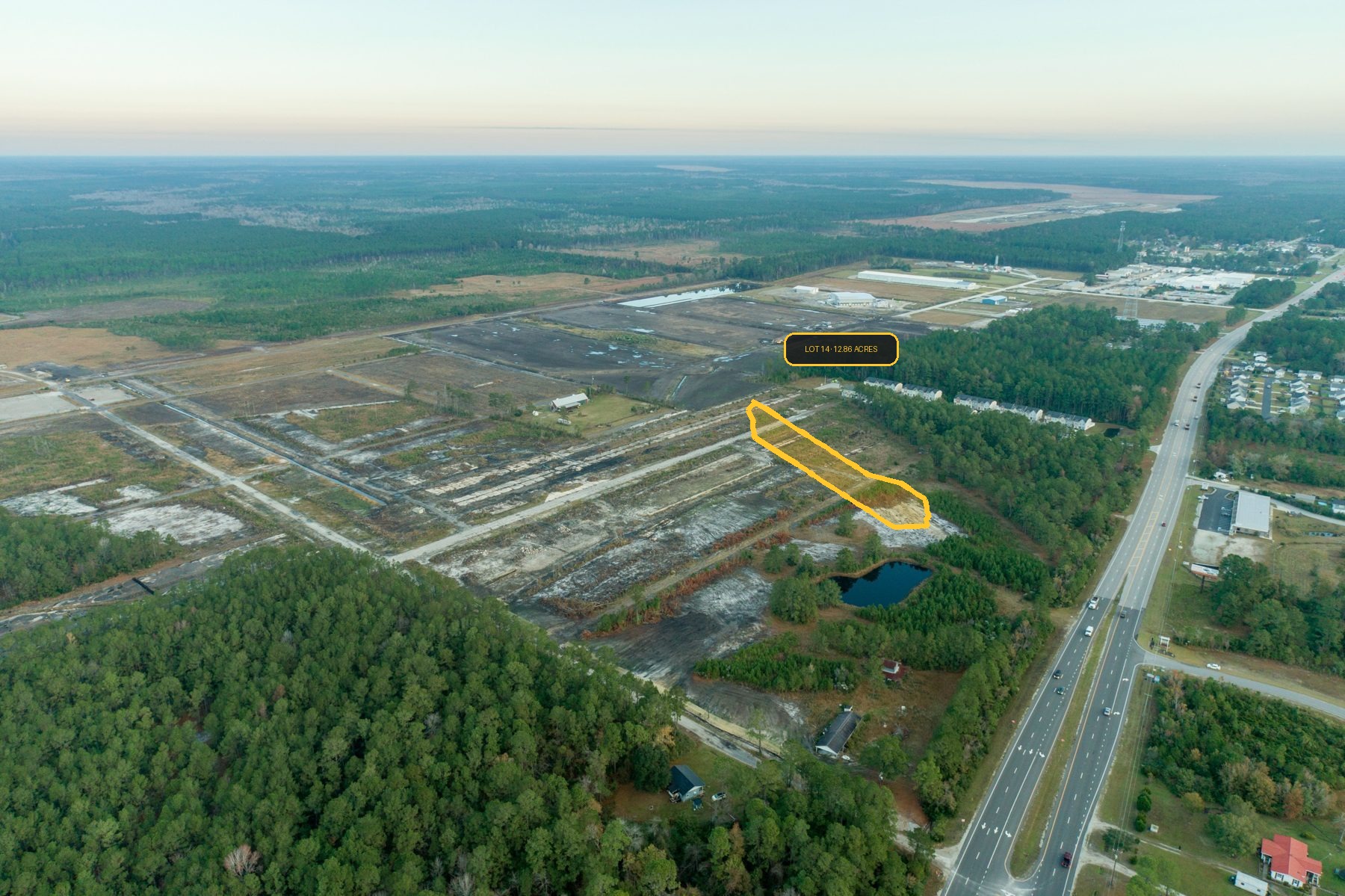Oblique aerial photo of Camp Davis Industrial Park Phase II with Lot 14 outlined in gold so the available 12.86-acre lot is easy to spot — Holly Ridge, North Carolina